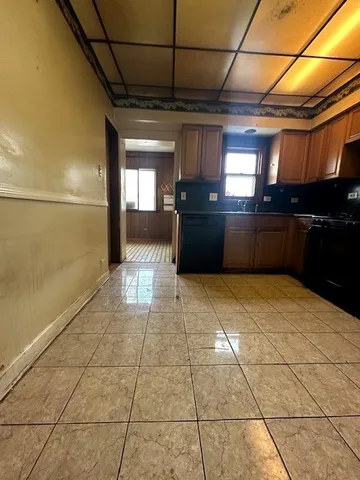 a kitchen with a stove top oven and cabinets