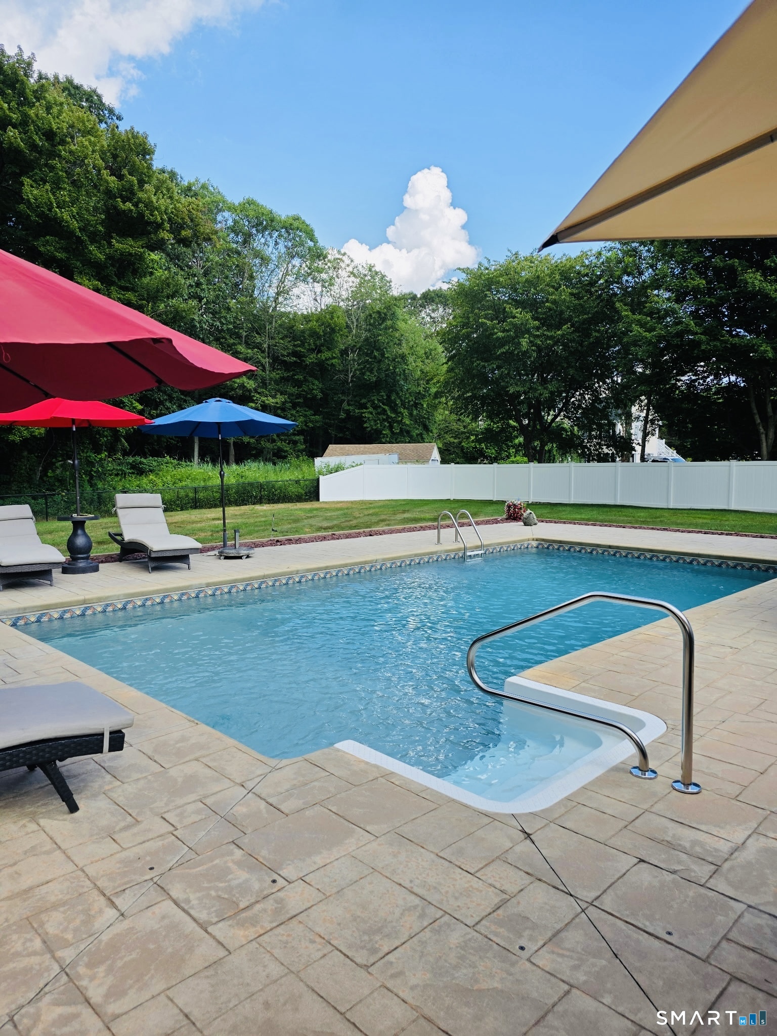 1514 Woodtick Road Wolcott, CT 06716 - Photo 3 of 23 a view of a swimming pool with a lawn chairs under an umbrella
