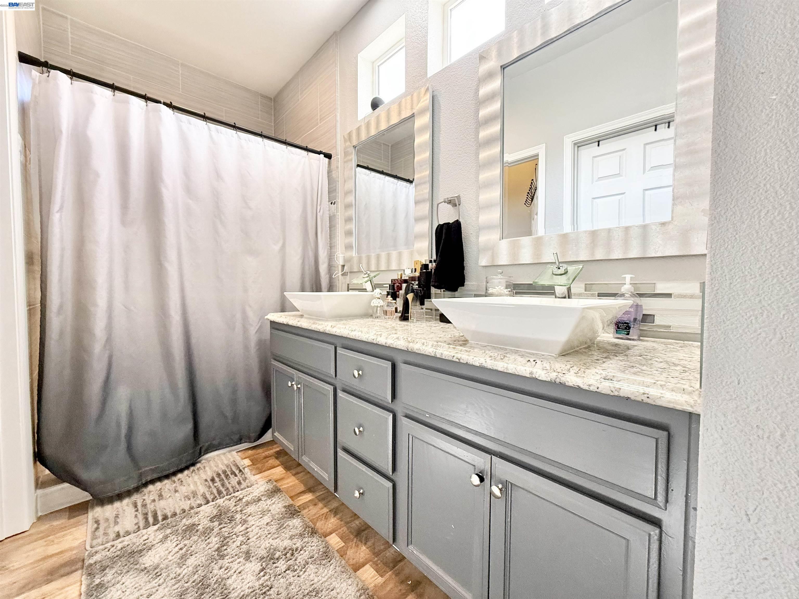 2408 Mountain Pride Court Modesto, CA 95355 - Photo 13 of 25 a bathroom with a sink and a mirror