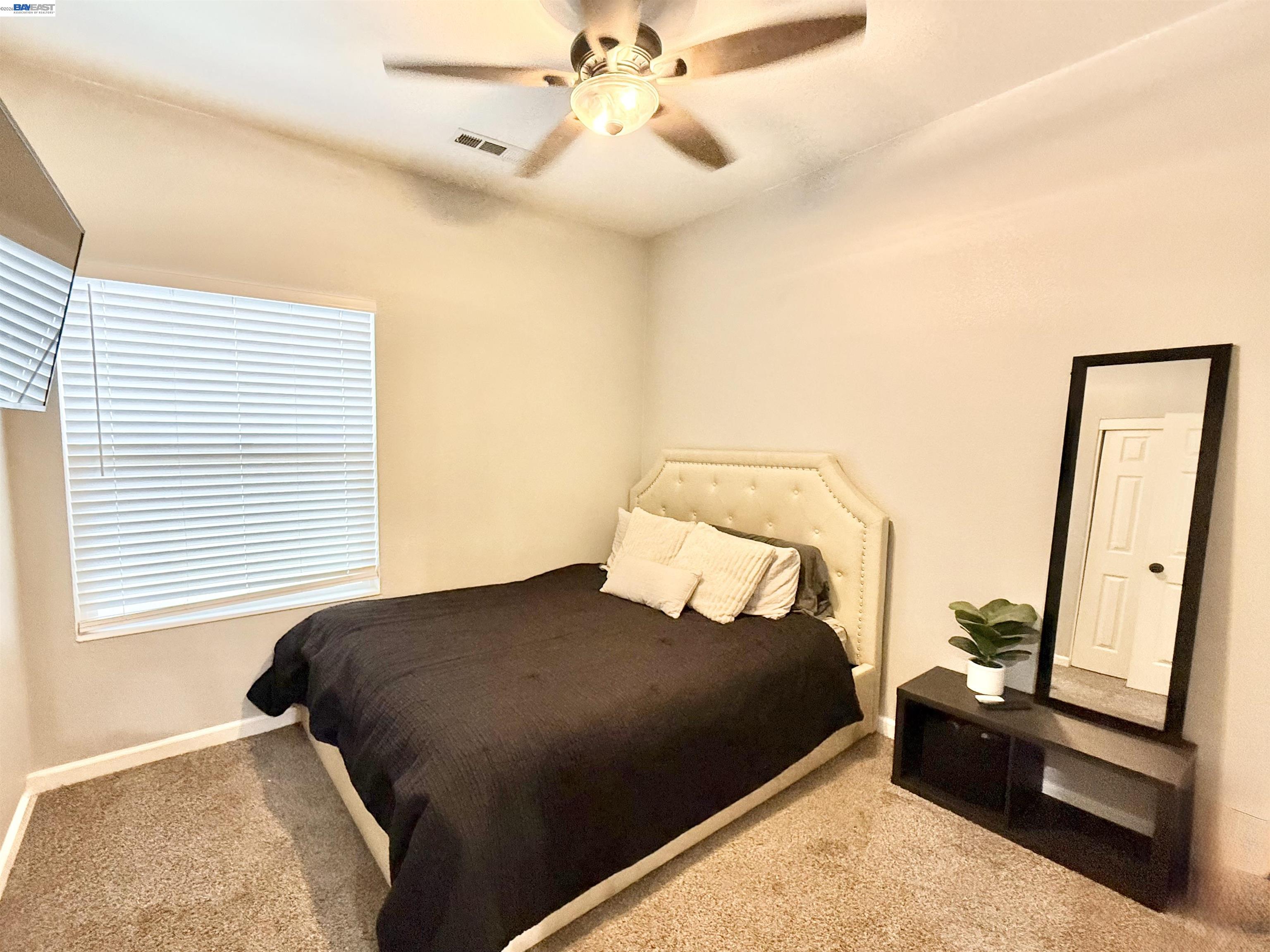 2408 Mountain Pride Court Modesto, CA 95355 - Photo 16 of 25 a bedroom with a bed and a large mirror