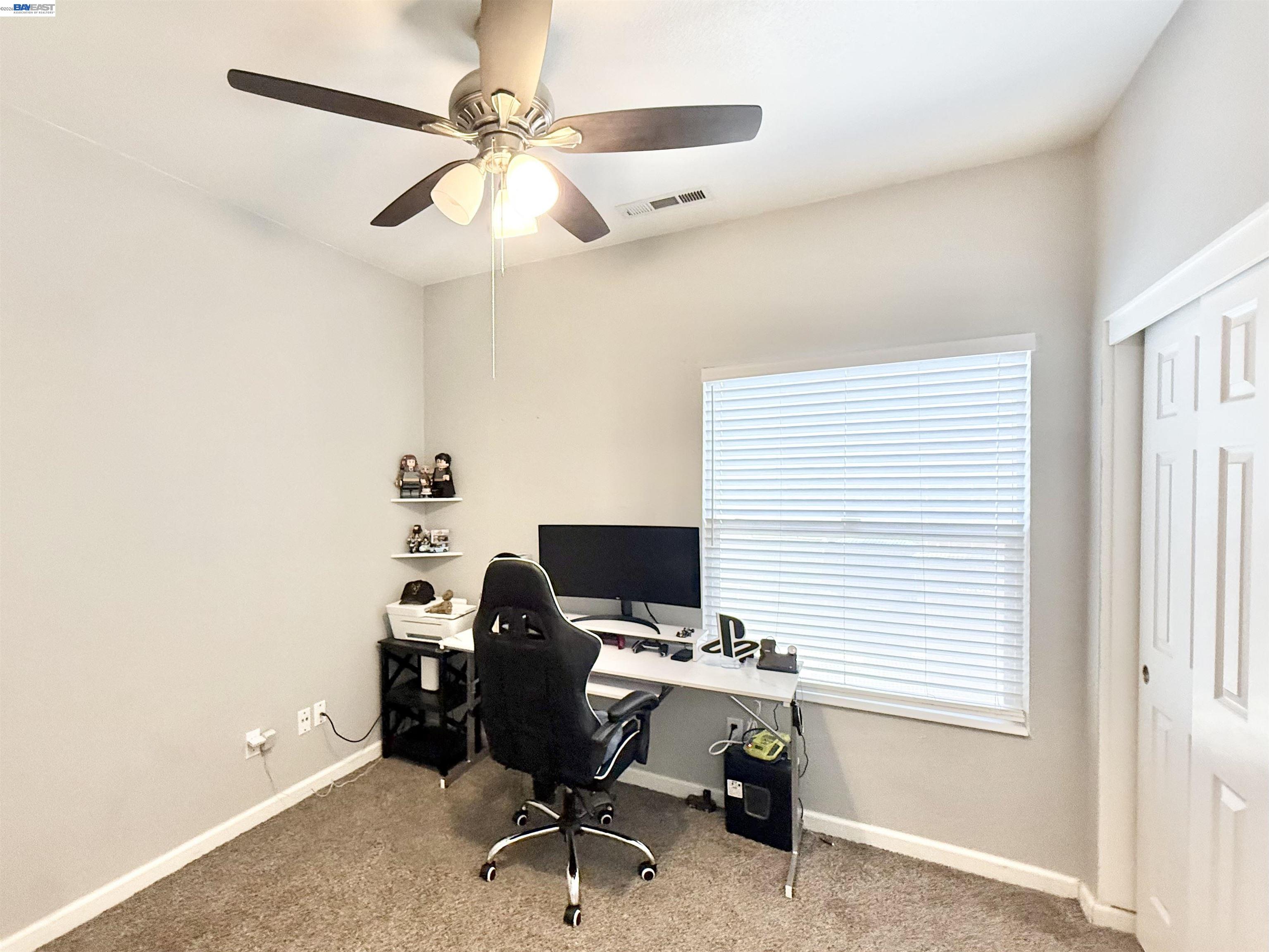 2408 Mountain Pride Court Modesto, CA 95355 - Photo 17 of 25 a view of a workspace with furniture and a window