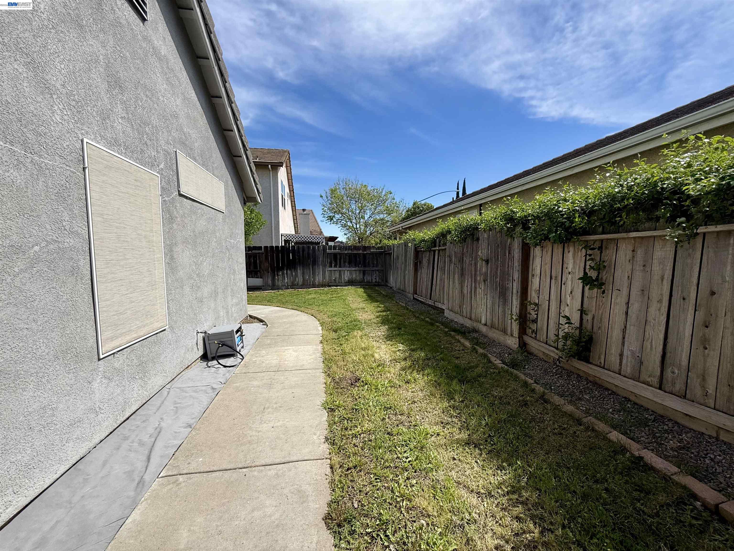 2408 Mountain Pride Court Modesto, CA 95355 - Photo 22 of 25 a view of small yard in front of house with wooden fence