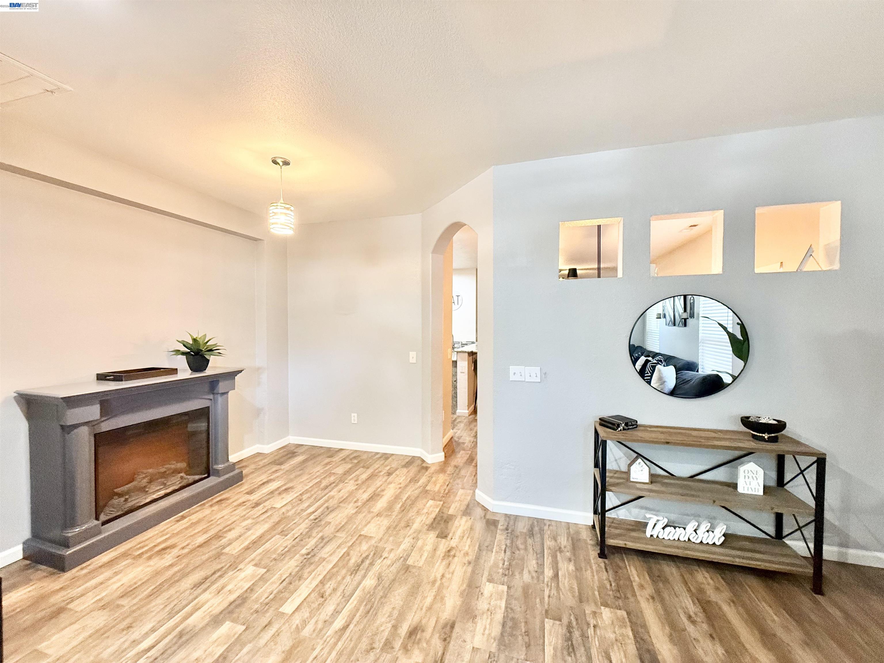 2408 Mountain Pride Court Modesto, CA 95355 - Photo 3 of 25 a view of an empty room and wooden floor