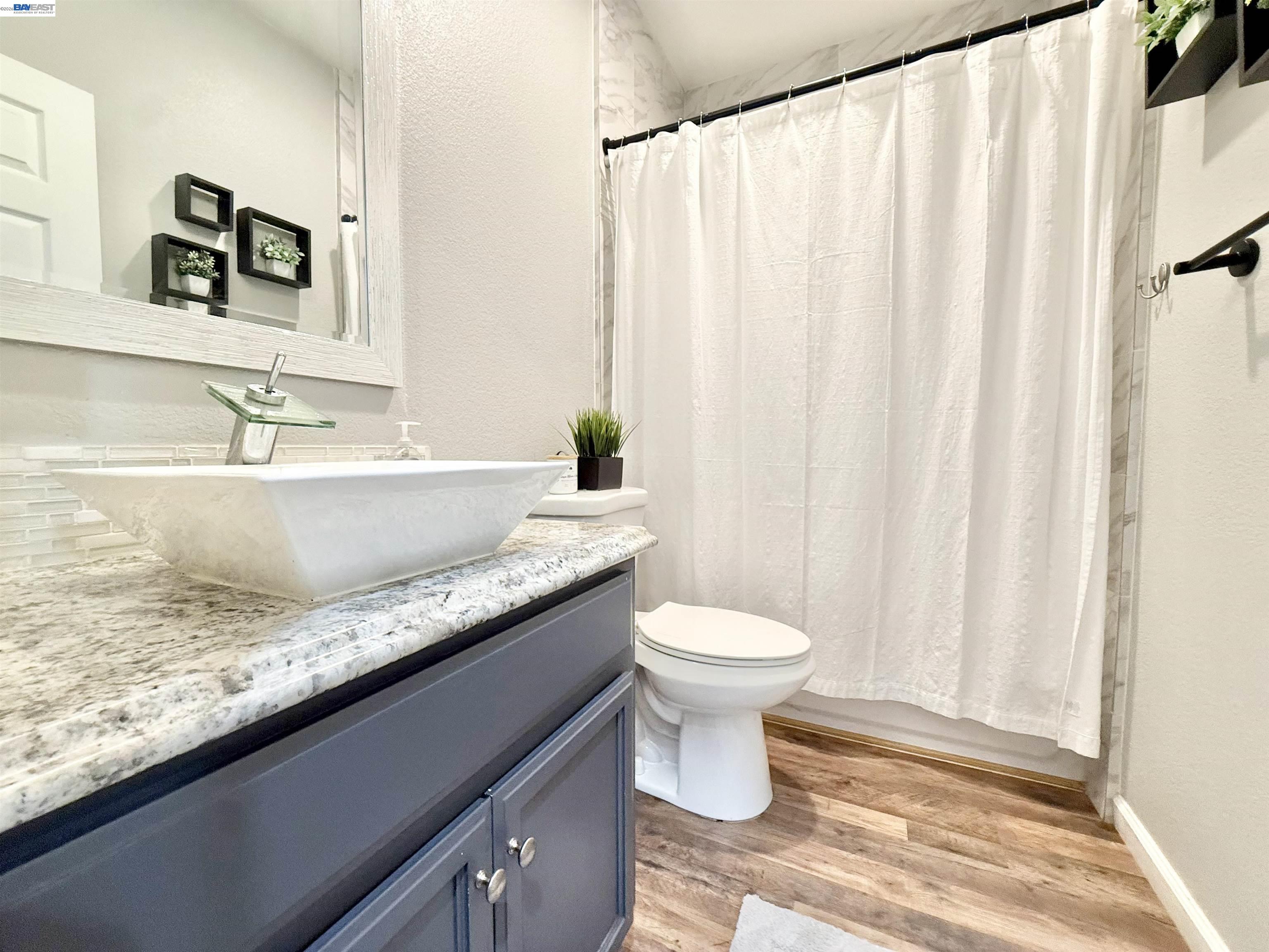 2408 Mountain Pride Court Modesto, CA 95355 - Photo 10 of 25 a bathroom with a granite countertop sink and a mirror