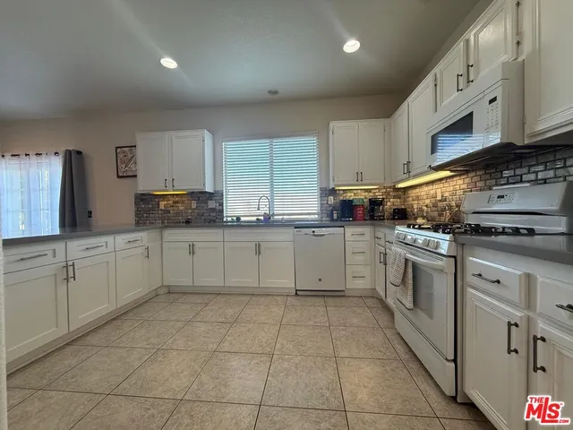 a kitchen with stainless steel appliances granite countertop a sink and cabinets
