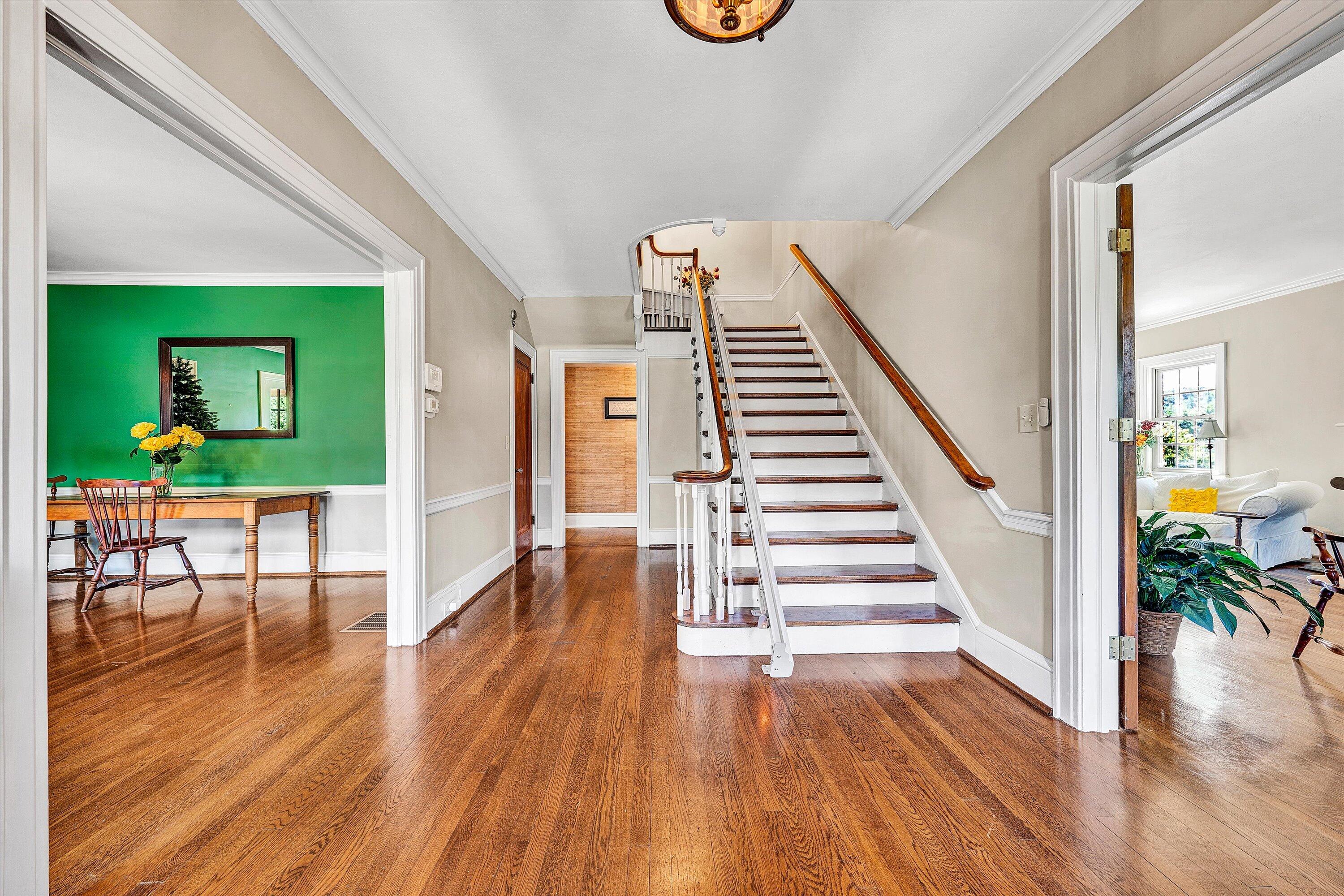 1930 Grandin Road Southwest Roanoke, VA 24015 - Photo 11 of 100 a view of a hallway with wooden floor stairs and a living room
