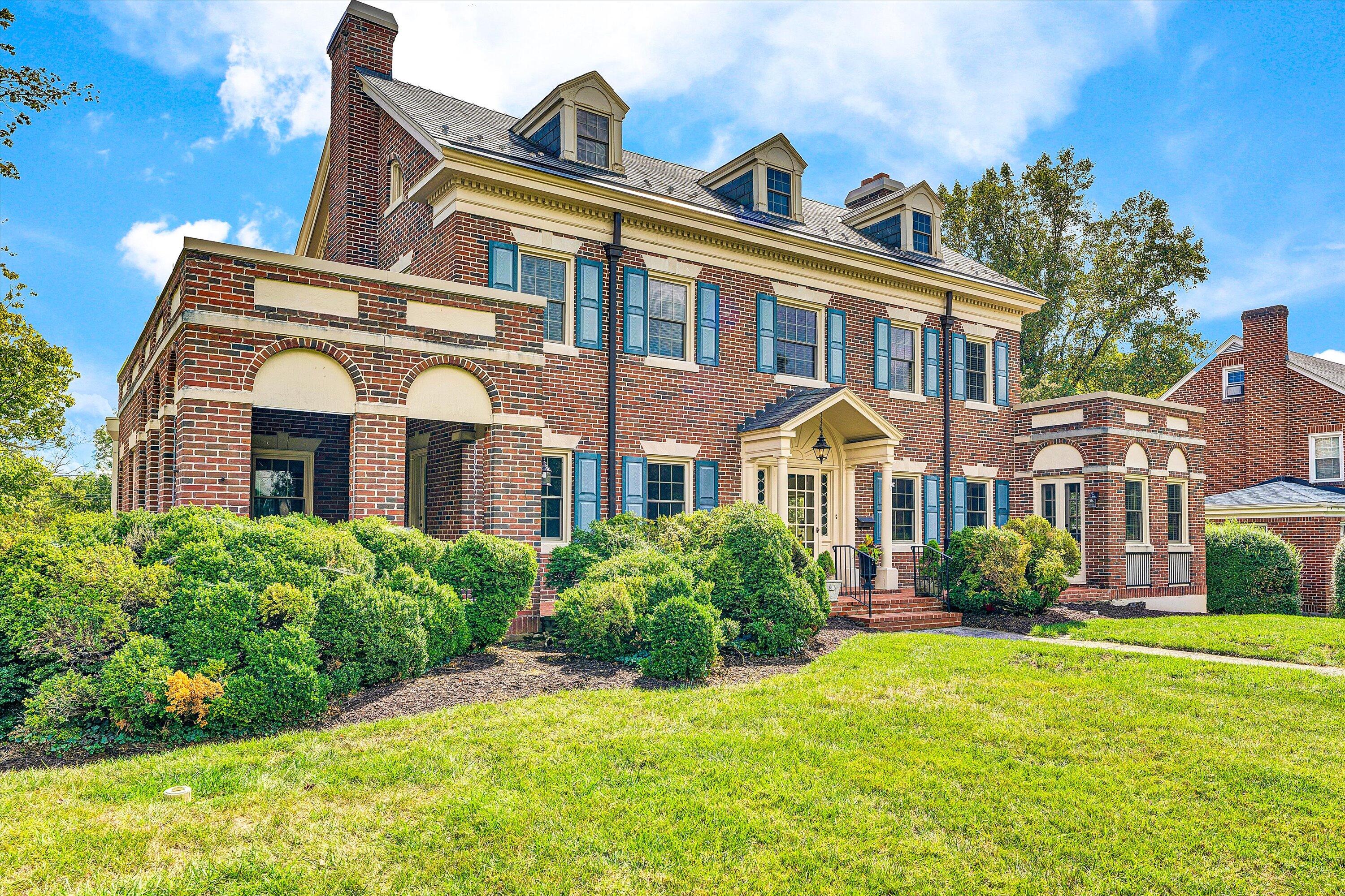 1930 Grandin Road Southwest Roanoke, VA 24015 - Photo 2 of 100 front view of a brick house with a yard