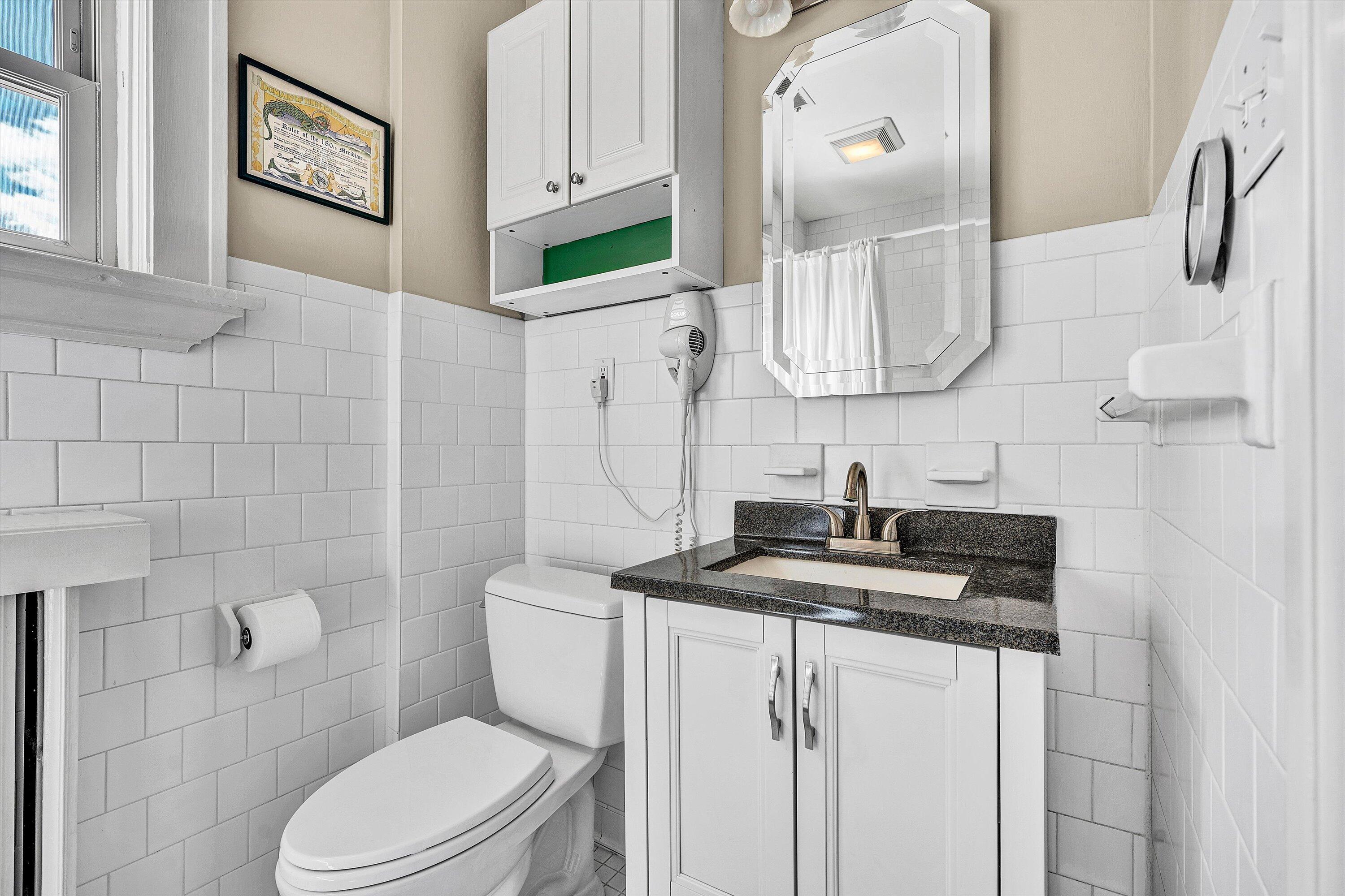 1930 Grandin Road Southwest Roanoke, VA 24015 - Photo 44 of 100 a bathroom with a granite countertop sink mirror and toilet