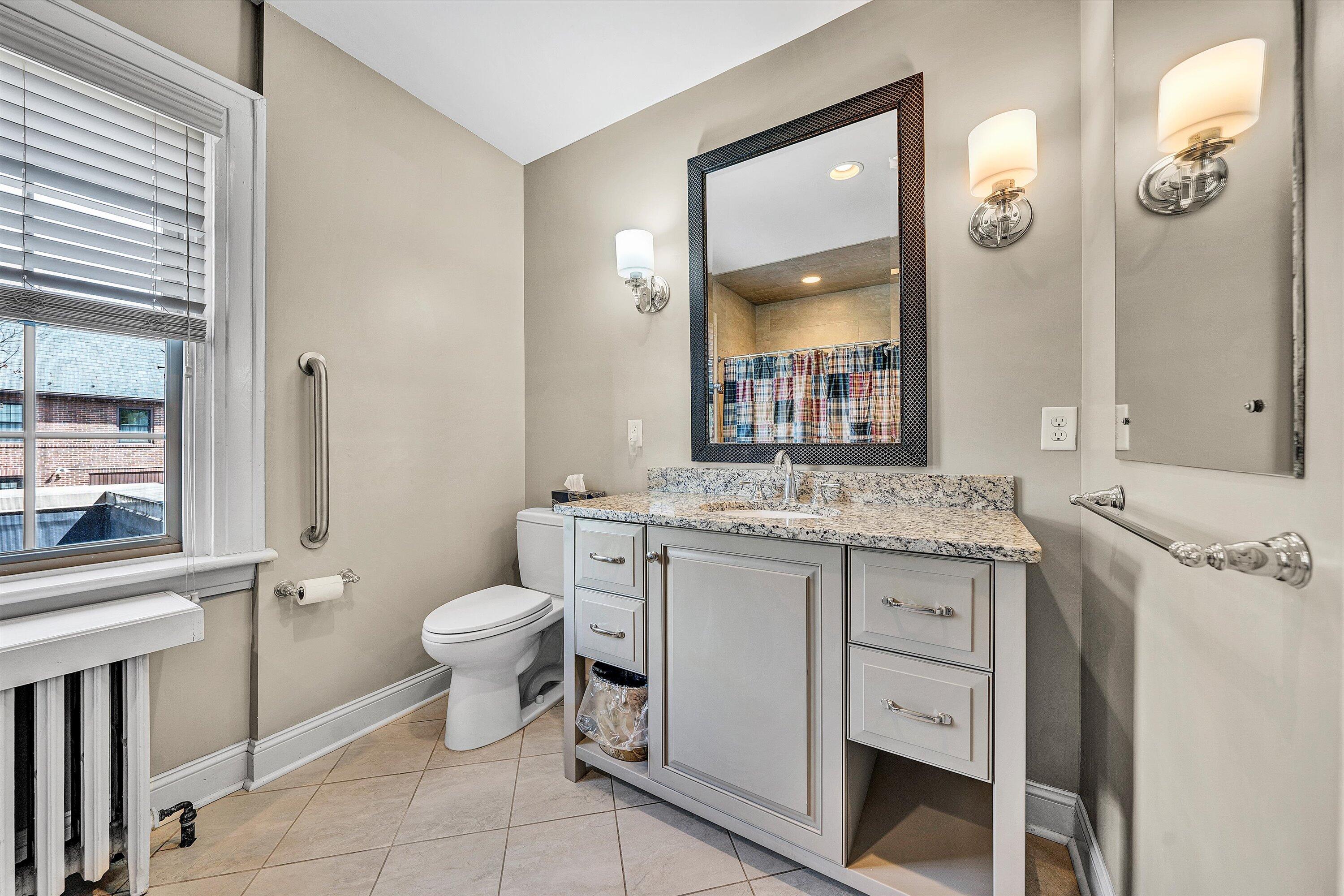 1930 Grandin Road Southwest Roanoke, VA 24015 - Photo 53 of 100 a bathroom with a granite countertop toilet sink and mirror