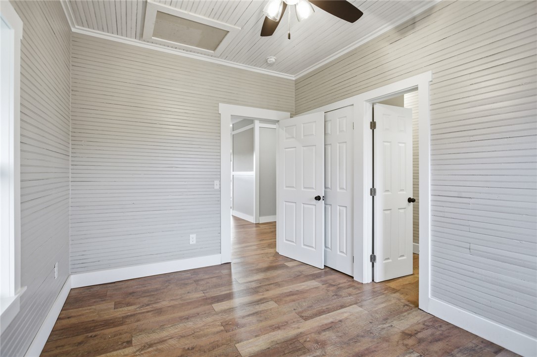 118 Grogan Road Westminster, SC 29693 - Photo 23 of 50 Horizontal shiplap walls complement the warm wood flooring in this versatile room.