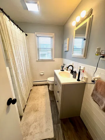 a bathroom with a sink and mirror with window