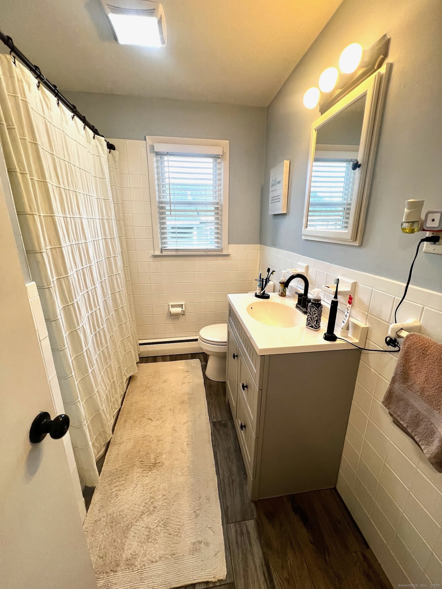 20 Glenfield Avenue Stratford, CT 06614 - Photo 8 of 12 a bathroom with a sink and mirror with window