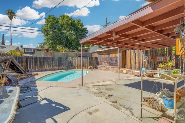 a view of a patio with a table and chairs