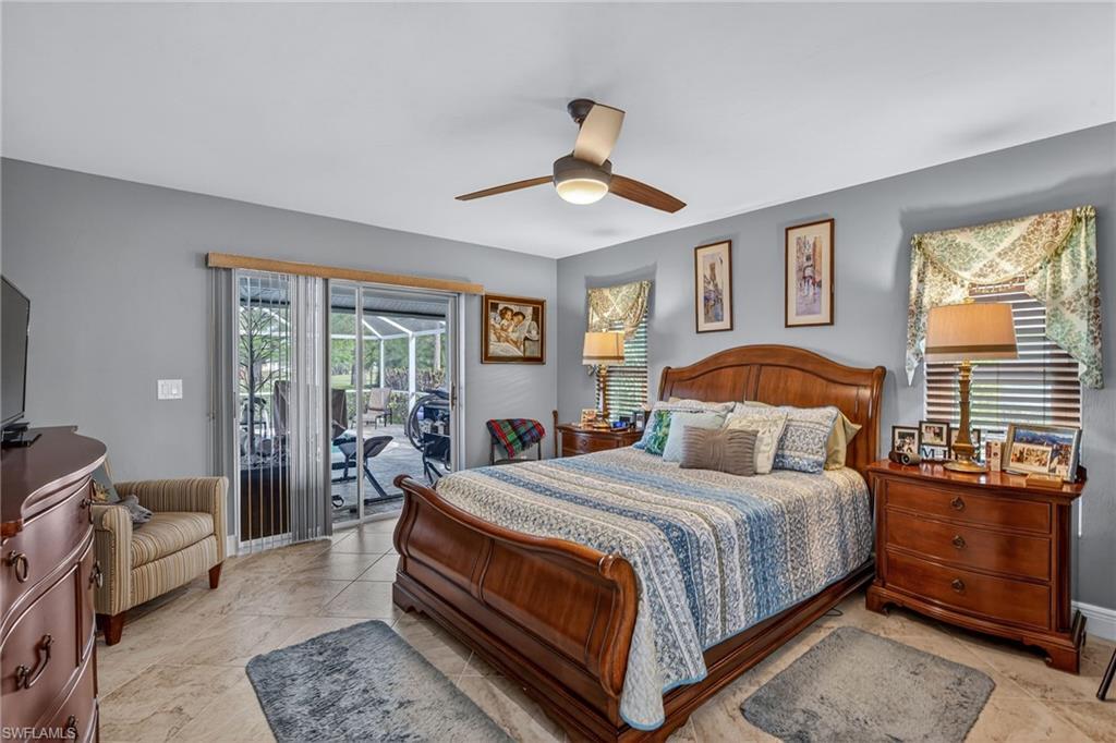 681 St Andrews Boulevard Naples, FL 34113 - Photo 12 of 20 a bedroom with a bed and wooden floor