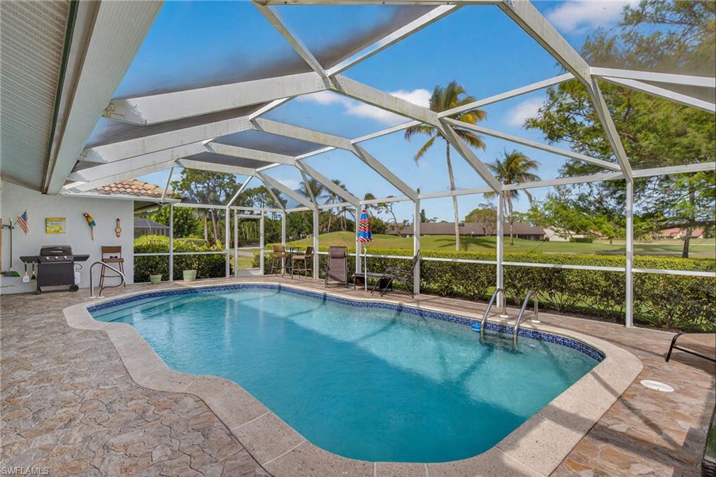 681 St Andrews Boulevard Naples, FL 34113 - Photo 17 of 20 a view of a swimming pool with a patio