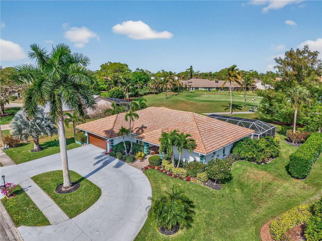 681 St Andrews Boulevard Naples, FL 34113 - Photo 18 of 20 a view of a house with a yard and potted plants