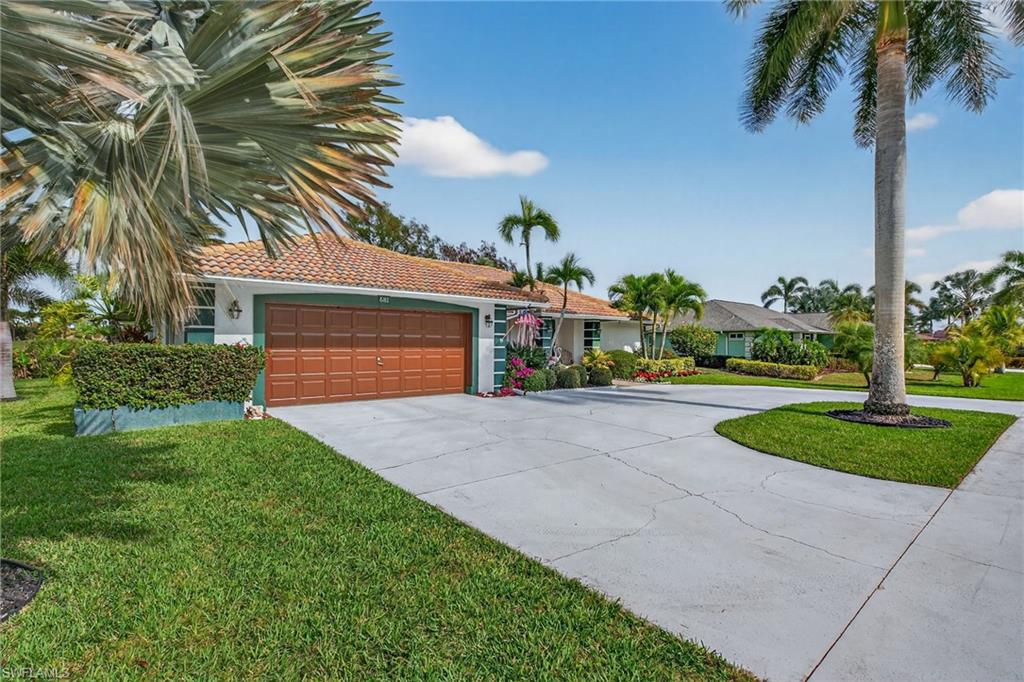 681 St Andrews Boulevard Naples, FL 34113 - Photo 20 of 20 a front view of a house with a yard and garage