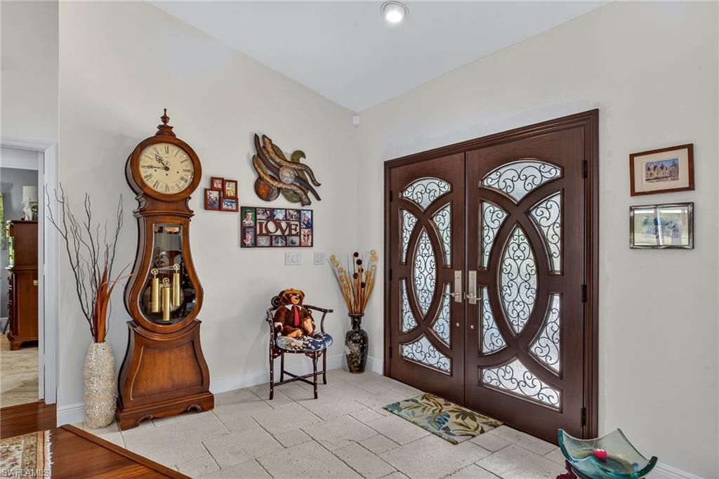 681 St Andrews Boulevard Naples, FL 34113 - Photo 3 of 20 a front view of a house with entryway