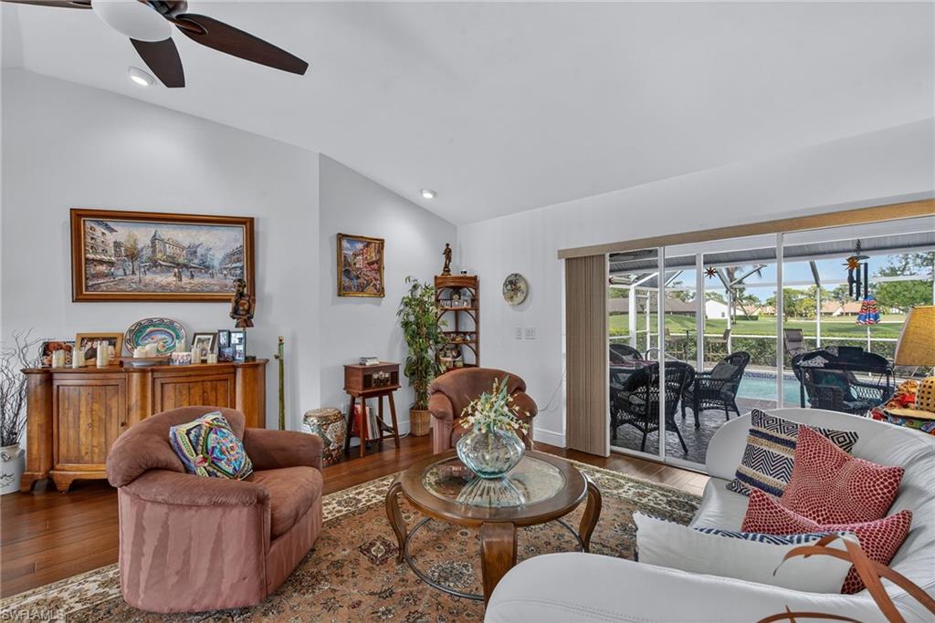 681 St Andrews Boulevard Naples, FL 34113 - Photo 7 of 20 a living room with furniture and a large window
