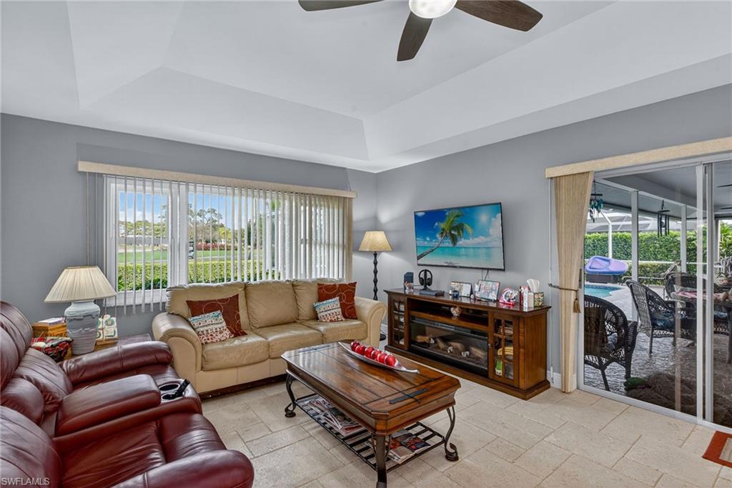 681 St Andrews Boulevard Naples, FL 34113 - Photo 8 of 20 a living room with furniture and a flat screen tv