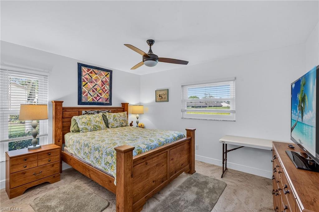 681 St Andrews Boulevard Naples, FL 34113 - Photo 10 of 20 a bedroom with a bed and a flat screen tv