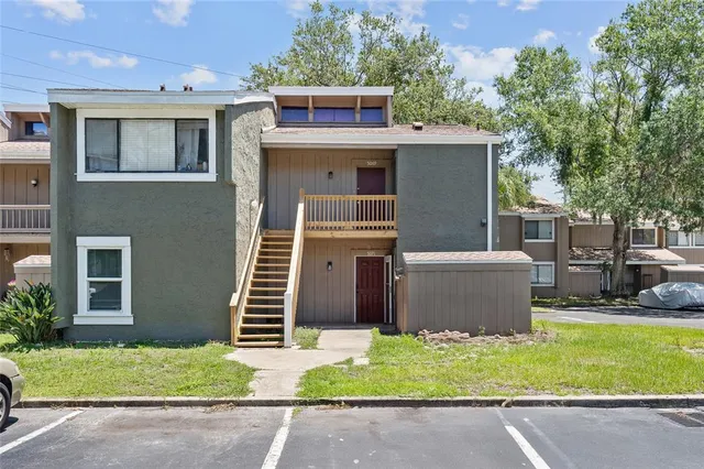 a front view of a house with a garden and plants
