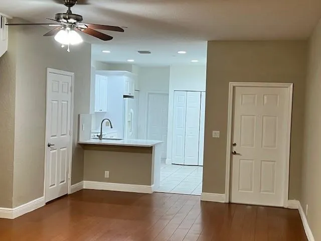 a view of a kitchen with a sink and a refrigerator