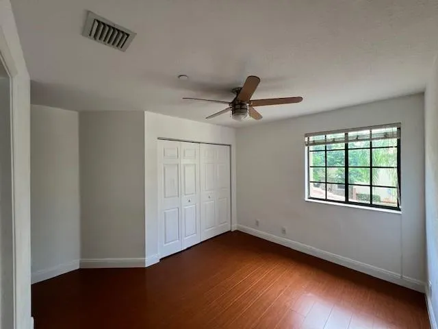 a view of a livingroom with a hardwood floor and a ceiling fan