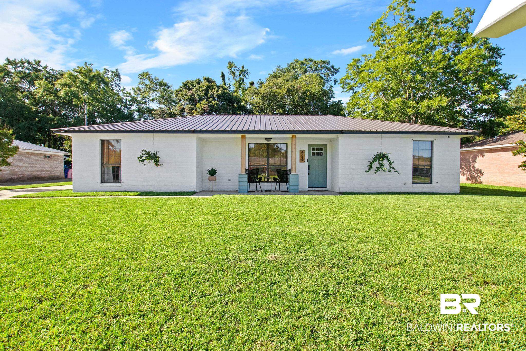 524 Ariel Avenue Foley, AL 36535 - Photo 1 of 37 White brick exterior with a dark metal roof
