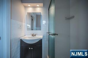 310 Union Street Carlstadt, NJ 07072 - Photo 17 of 24 a bathroom with a sink and a mirror