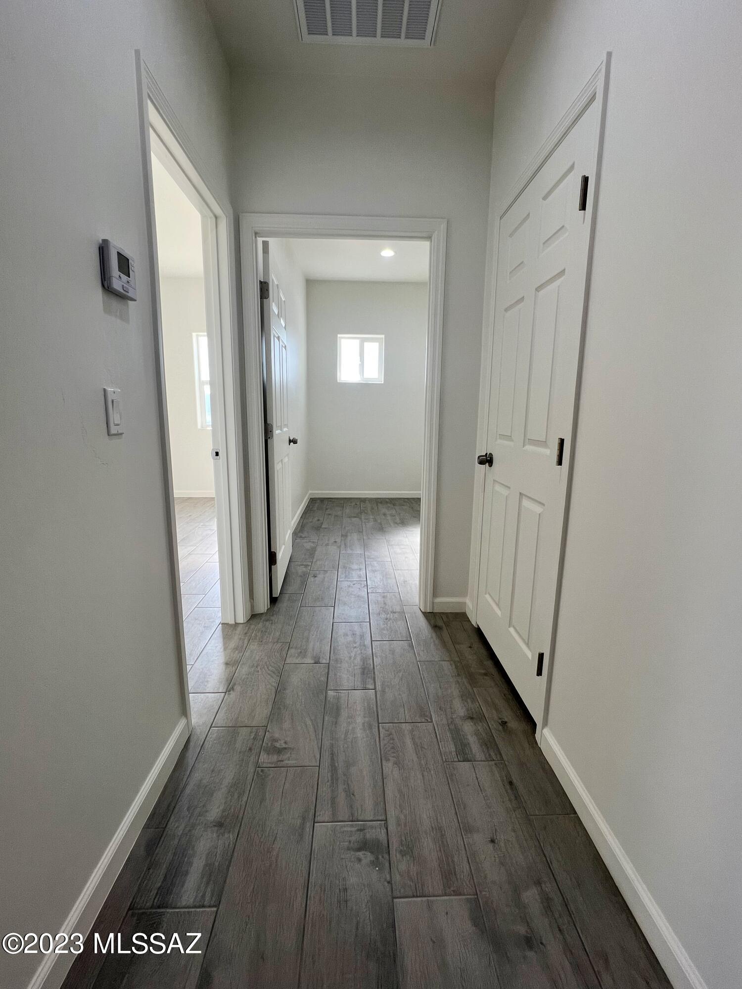 353 Dock Street Rio Rico, AZ 85648 - Photo 16 of 50 a view of a hallway with wooden floor