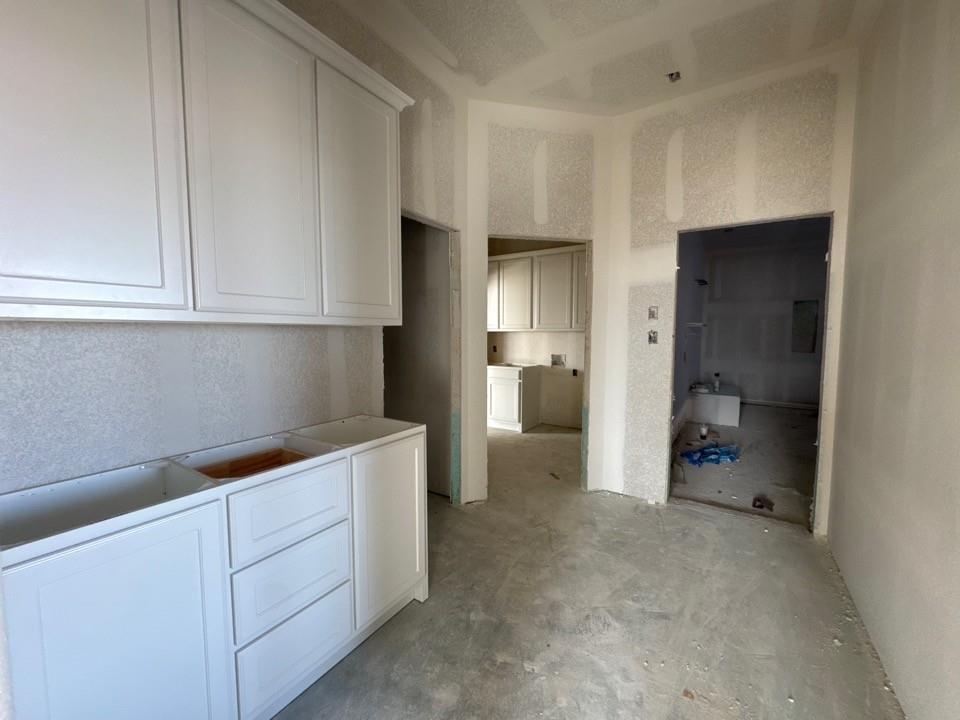 197 Mdw Vista Drive Rhome, TX 76078 - Photo 6 of 13 a kitchen with cabinets and a refrigerator