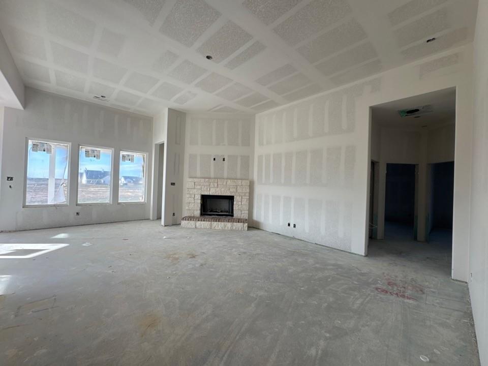 197 Mdw Vista Drive Rhome, TX 76078 - Photo 7 of 13 a view of an empty room with a fireplace and a window