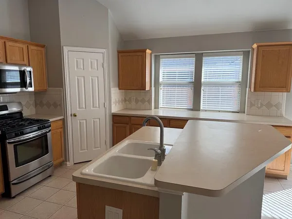 a room with pool table and windows