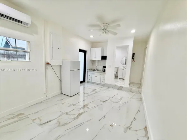 a view of a kitchen with a refrigerator