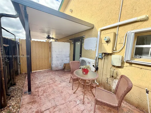 a view of a porch with furniture and entryway