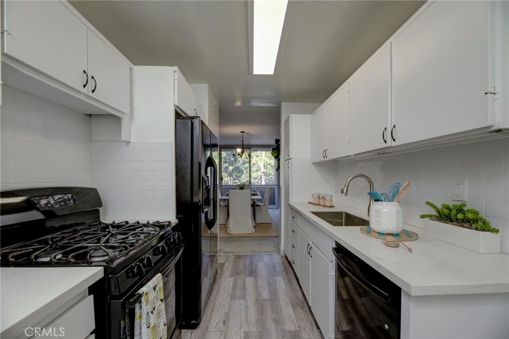 6315 Green Valley Circle, Unit 200 Culver City, CA 90230 - Photo 15 of 40 a kitchen with a stove a sink and a refrigerator
