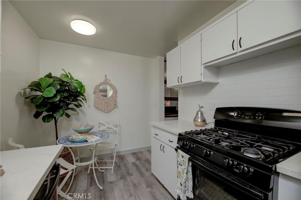6315 Green Valley Circle, Unit 200 Culver City, CA 90230 - Photo 17 of 40 a kitchen with granite countertop a stove a chimney a sink and cabinets