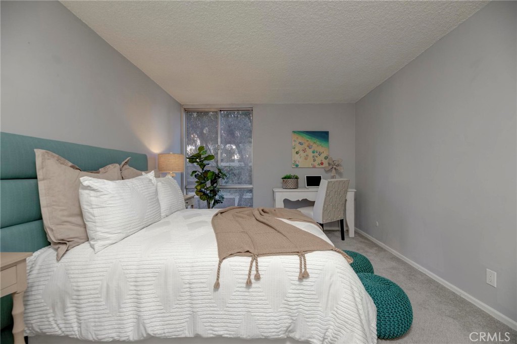 6315 Green Valley Circle, Unit 200 Culver City, CA 90230 - Photo 21 of 40 a bedroom with a bed table chair and a window