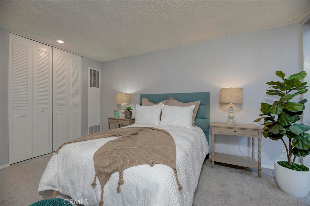 6315 Green Valley Circle, Unit 200 Culver City, CA 90230 - Photo 22 of 40 a spacious bedroom with a bed and a potted plant