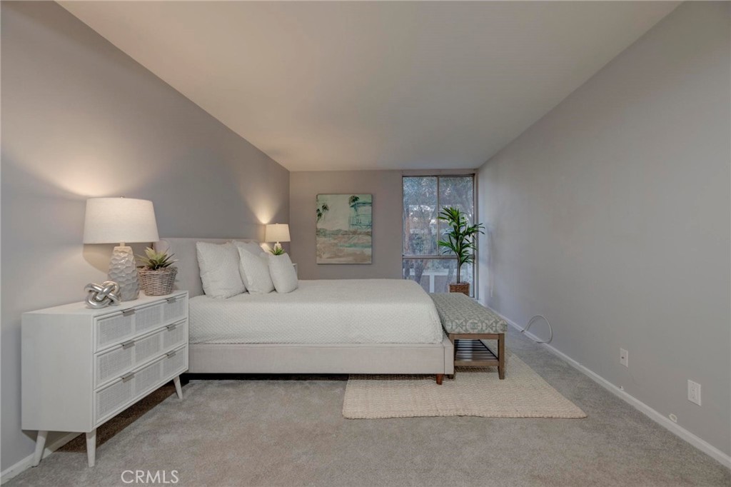 6315 Green Valley Circle, Unit 200 Culver City, CA 90230 - Photo 25 of 40 a spacious bedroom with a bed and a lamp