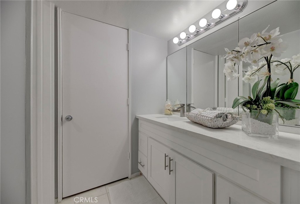 6315 Green Valley Circle, Unit 200 Culver City, CA 90230 - Photo 29 of 40 a bathroom with a granite countertop sink a large mirror and a shower