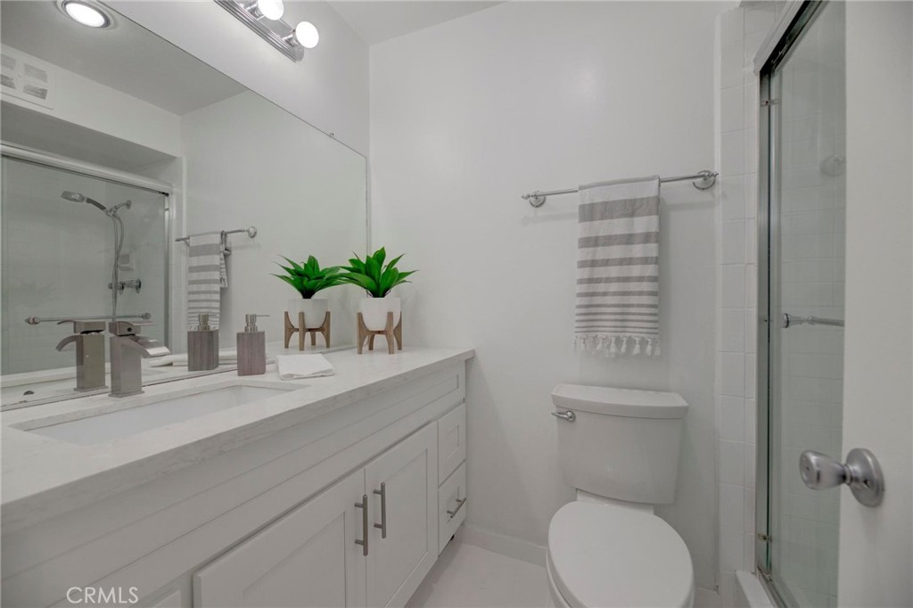 6315 Green Valley Circle, Unit 200 Culver City, CA 90230 - Photo 31 of 40 a bathroom with a sink a toilet and a mirror