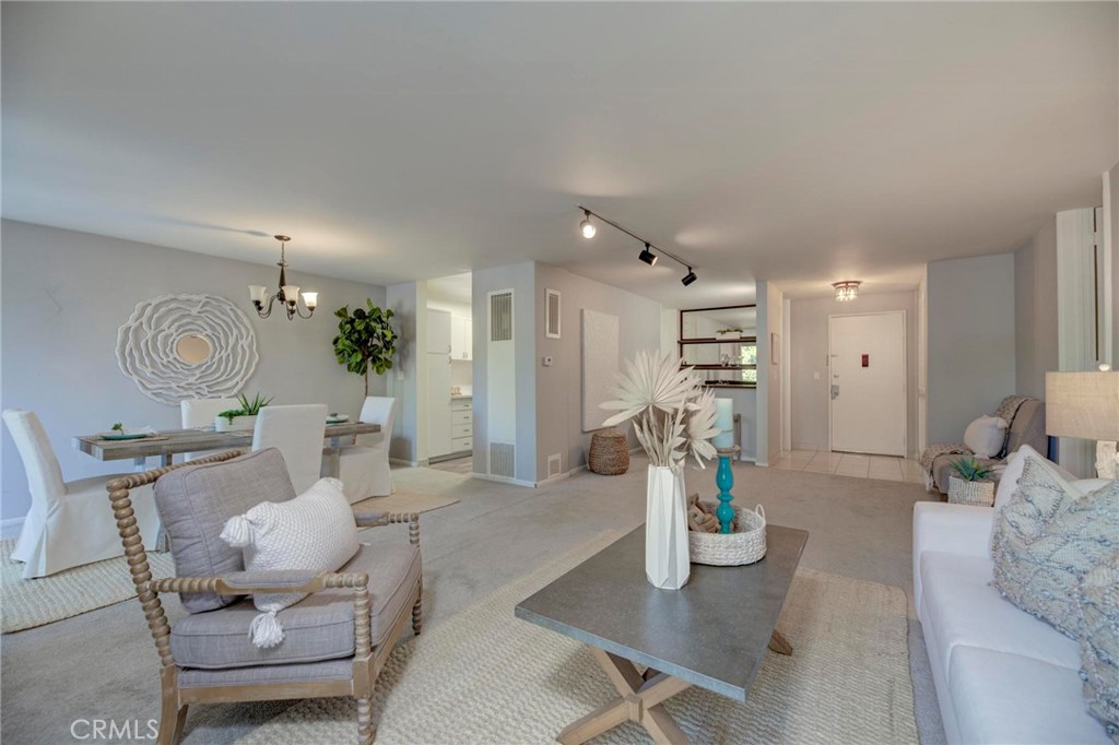 6315 Green Valley Circle, Unit 200 Culver City, CA 90230 - Photo 8 of 40 a living room with furniture a chandelier and a dining table