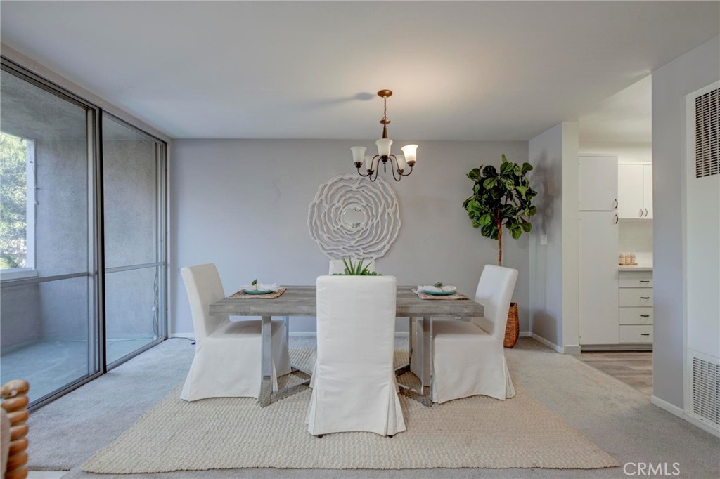 6315 Green Valley Circle, Unit 200 Culver City, CA 90230 - Photo 9 of 40 a living room with furniture a chandelier and a window