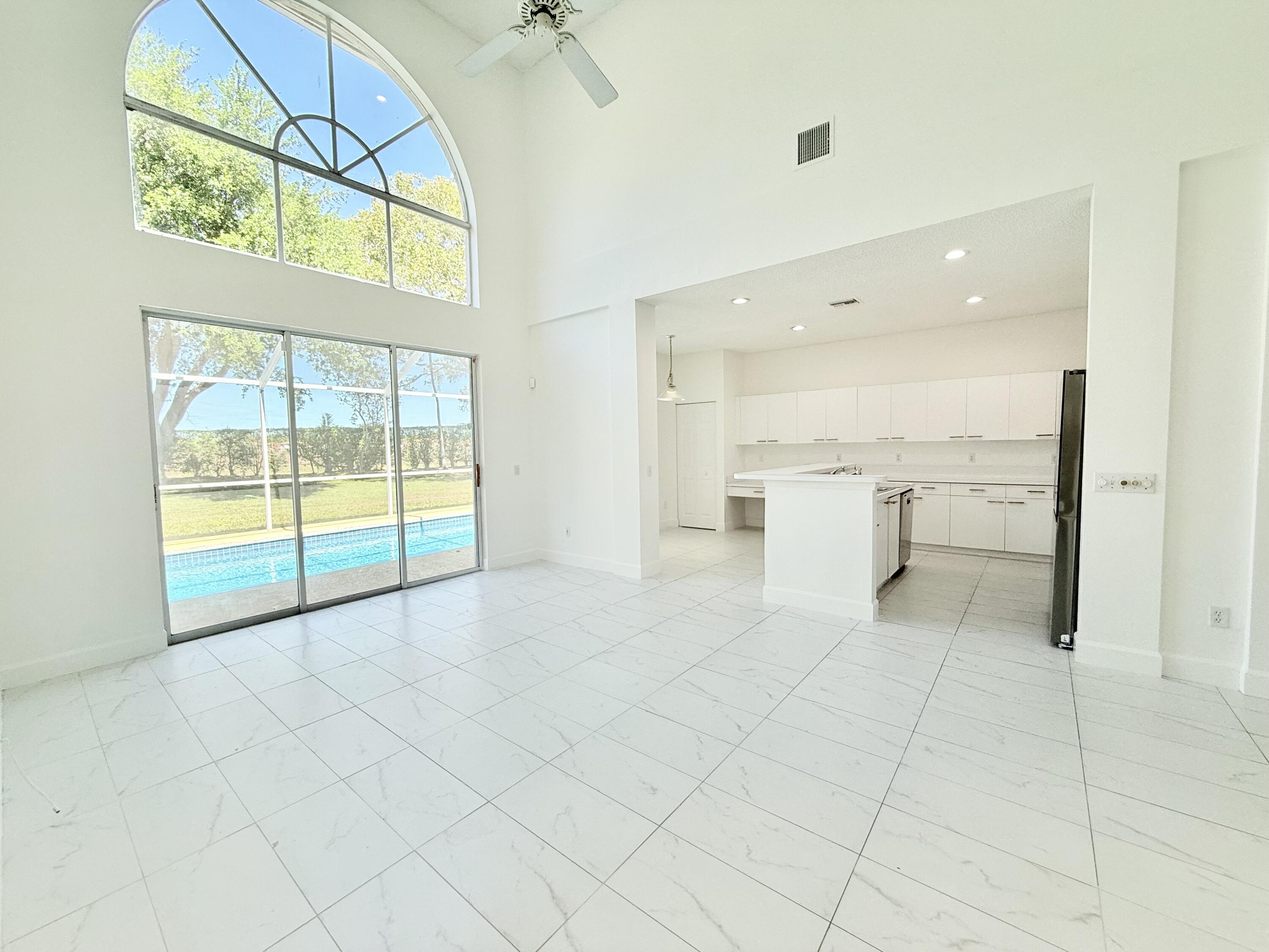 10875 Old Bridgeport Lane Boca Raton, FL 33498 - Photo 20 of 39 Kitchen and family room overlooking pool