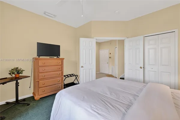 a bedroom with two beds and a dresser