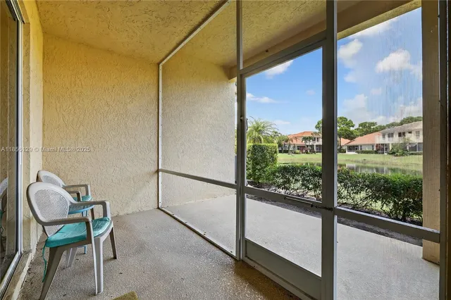 a view of a lake with a big yard and potted plants