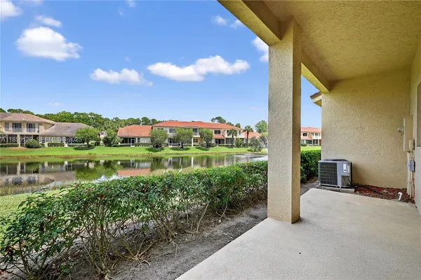 a house view with outdoor space and a lake view