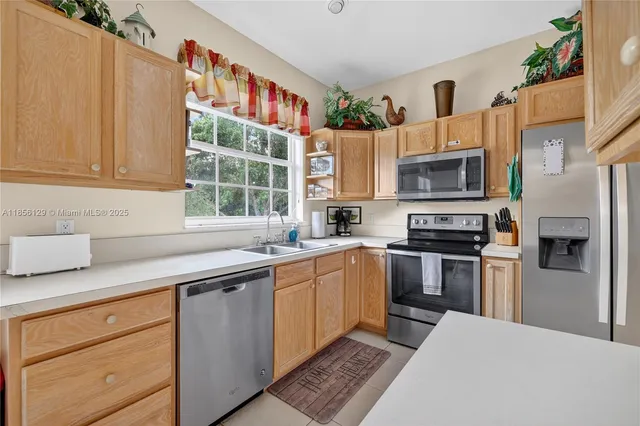 a kitchen with a sink stove and microwave
